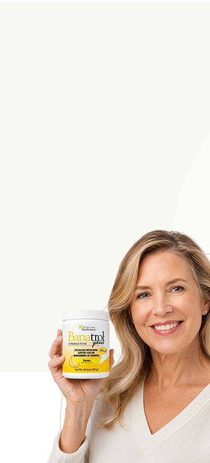 Woman holding a container of Banatrol Plus